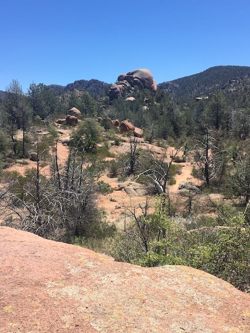 A rounded tower of various sizes of granite boulders